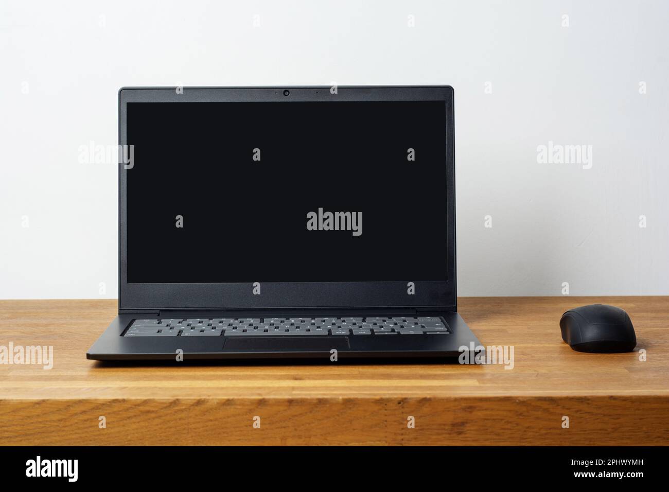 Shot of modern workspace with blank screen laptop on wooden table with ...