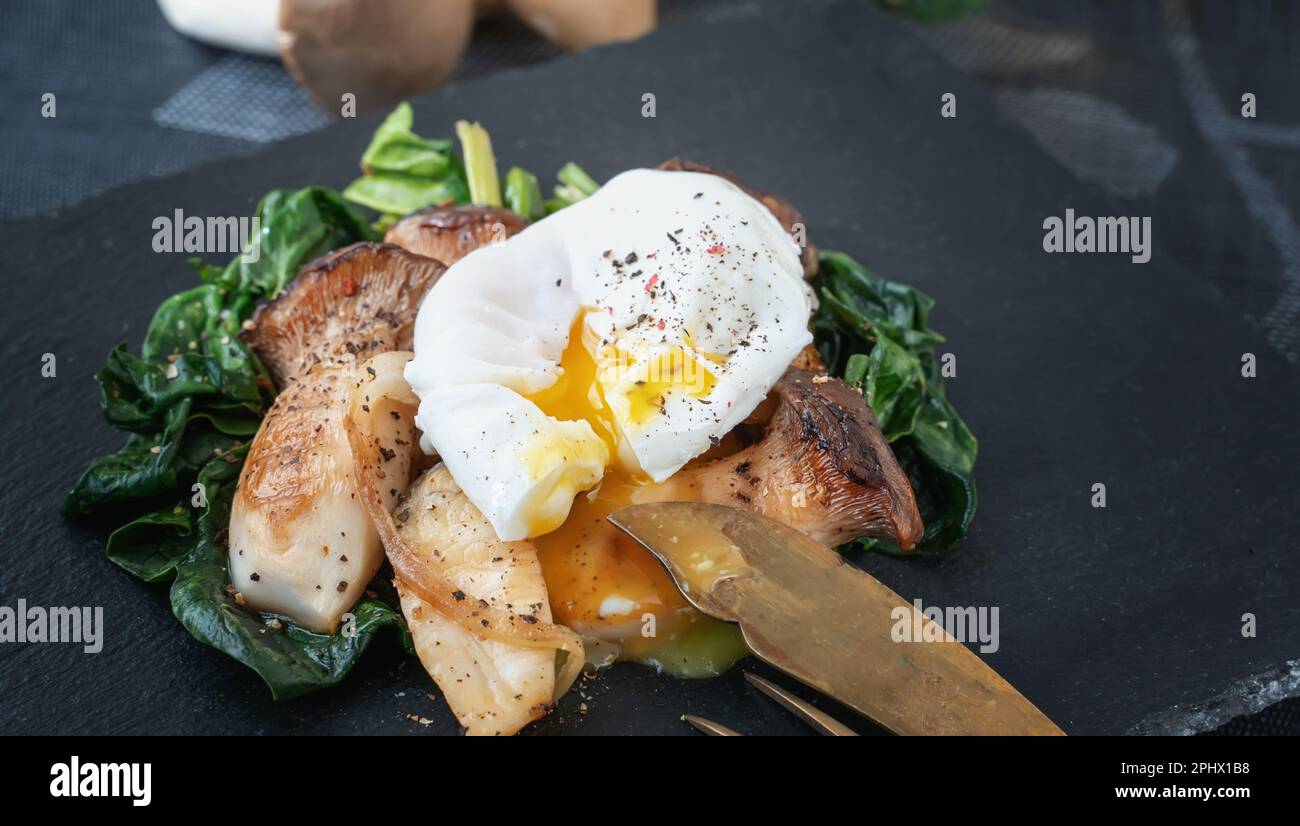 Grilled Pleurotus eryngii mushrooms with poached egg and spinach. Hot