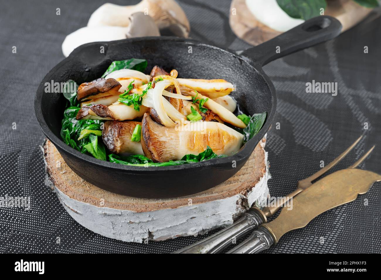Grilled Pleurotus eryngii mushrooms with poached egg and spinach. Hot
