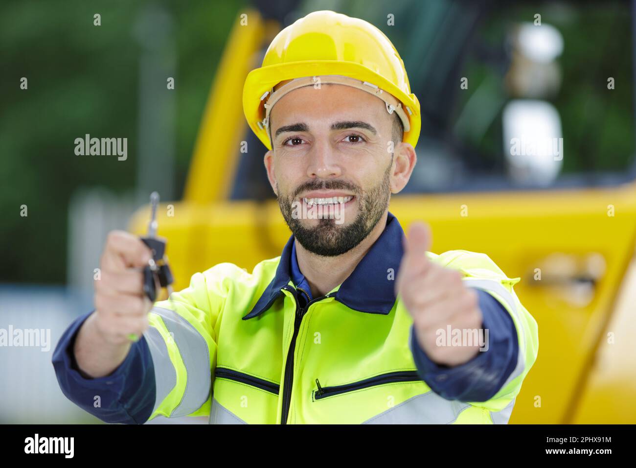 male heavy equipment driver showing key Stock Photo Alamy