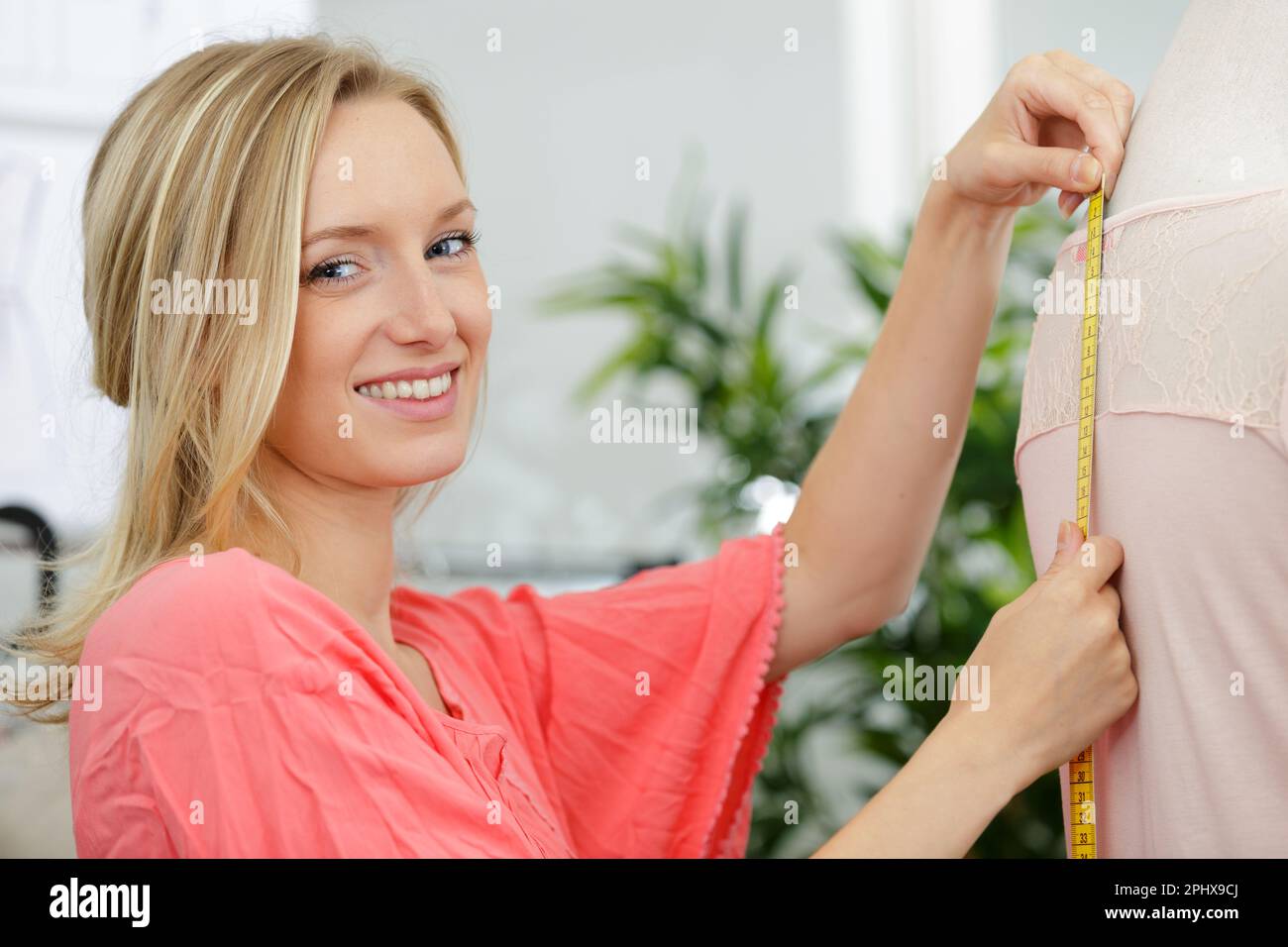 young tailor doing some measurement Stock Photo