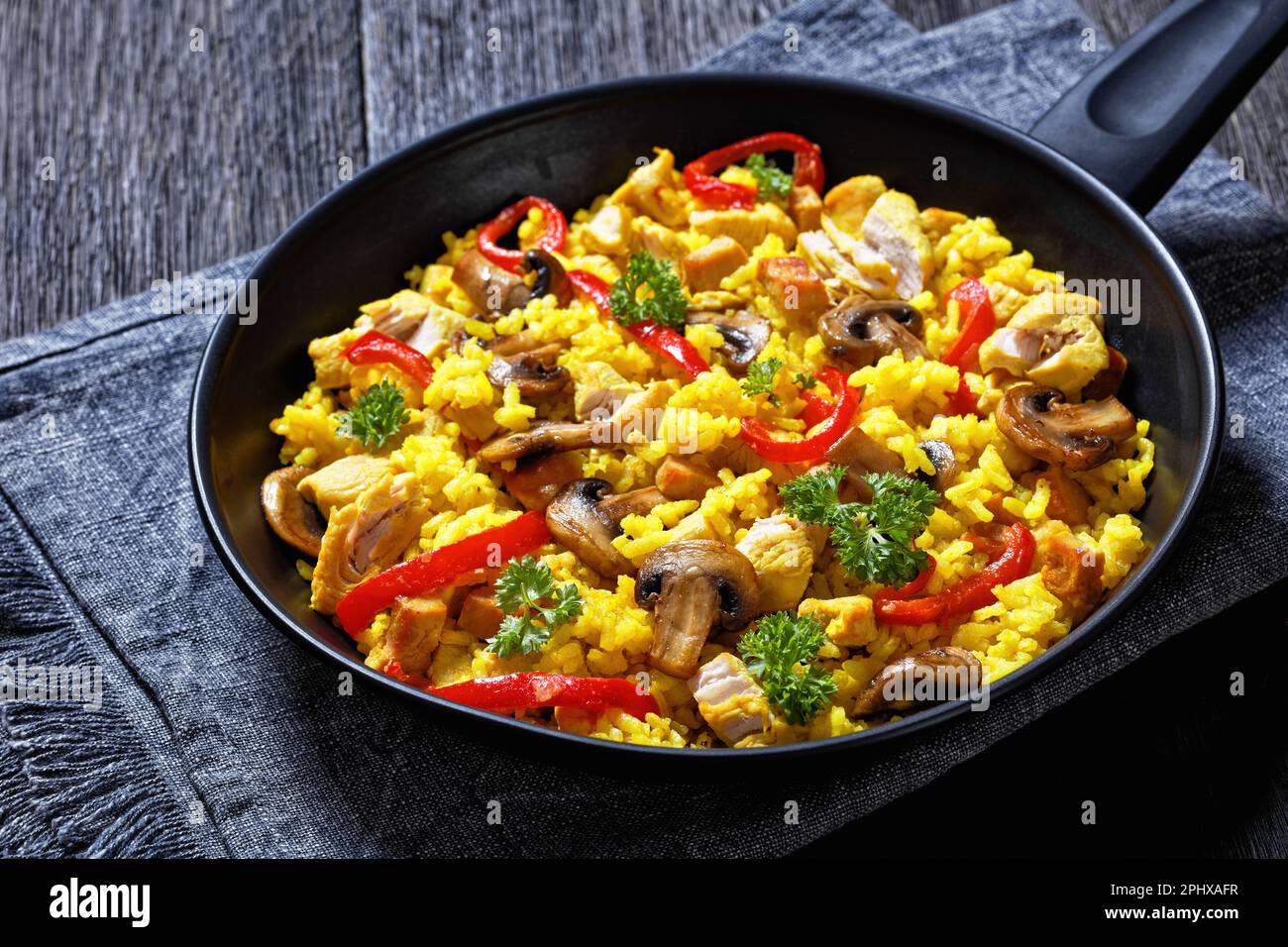 Chicken Paella of arborio rice, chicken fillet, mushrooms, julienned
