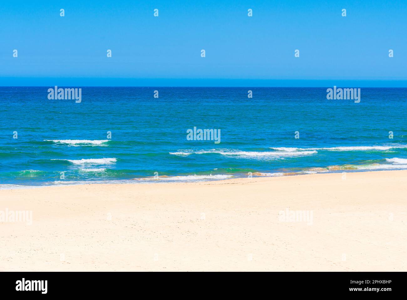 A beach with a blue sky Stock Photo