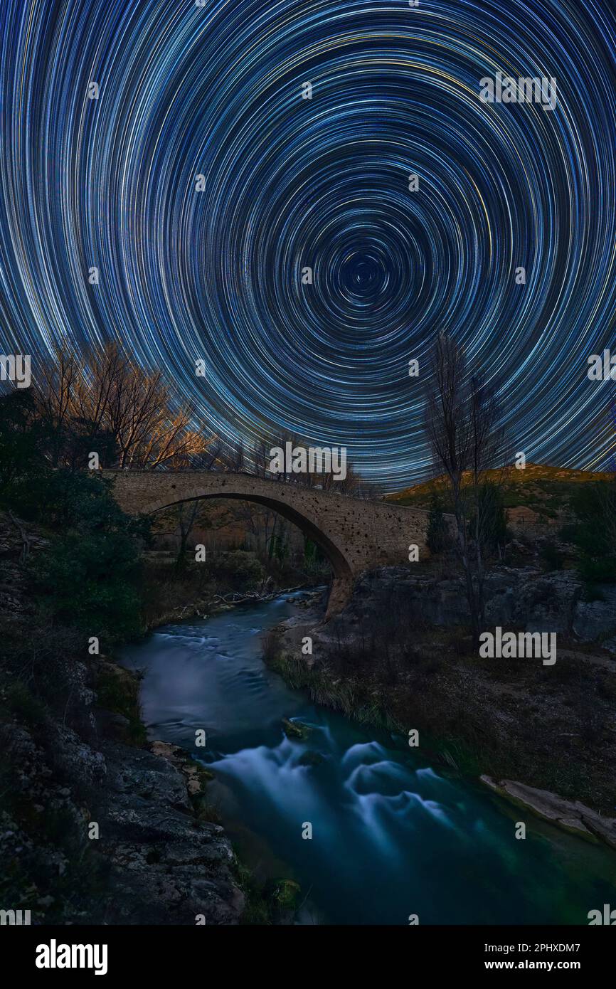 Fonseca old bridge in Teruel at night with star trails Stock Photo