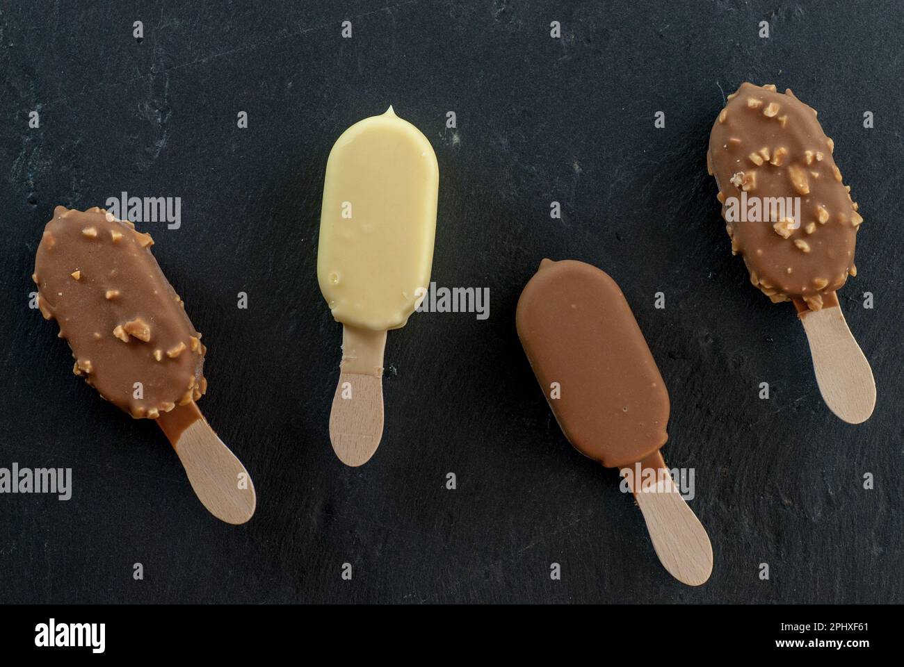 assorted mini ice creams on stick on black Stock Photo Alamy
