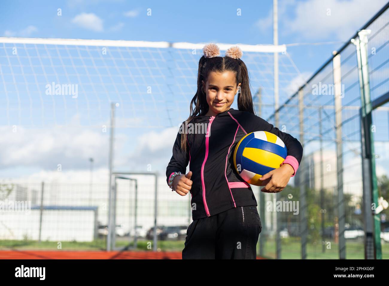 Pretty teen girl with brunette hair, volleyball ball Stock Photo - Alamy