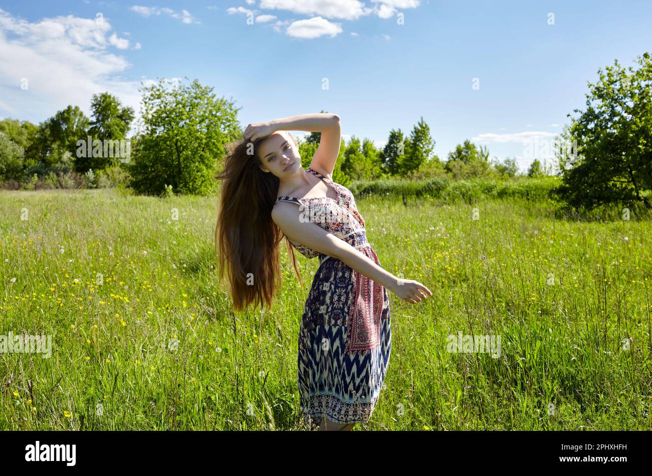 Beautiful model walking in spring or summer field. Portrait of ...