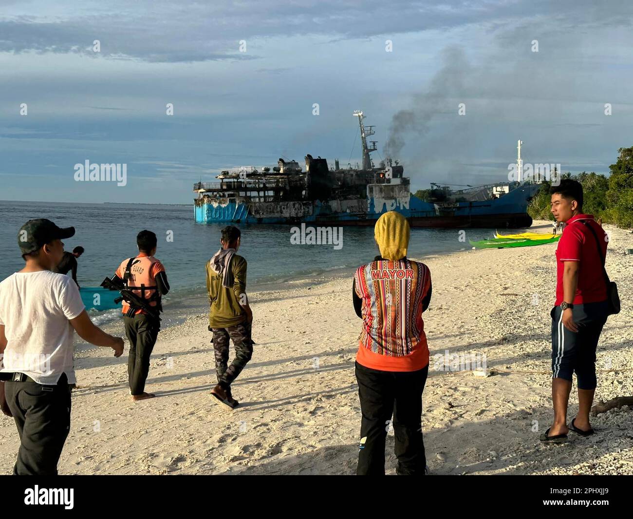 (230330) -- BASILAN PROVINCE, March 30, 2023 (Xinhua) -- The damaged M/V Lady Mary Joy 3 is seen along the coast of Basilan Province, the Philippines, March 30, 2023. A ferry carrying more than 200 people caught fire in the southern Philippines late Wednesday night, killing at least 10 passengers, the Philippine Coast Guard (PCG) said Thursday. (Pilas Island Local Government/Handout via Xinhua) Stock Photo