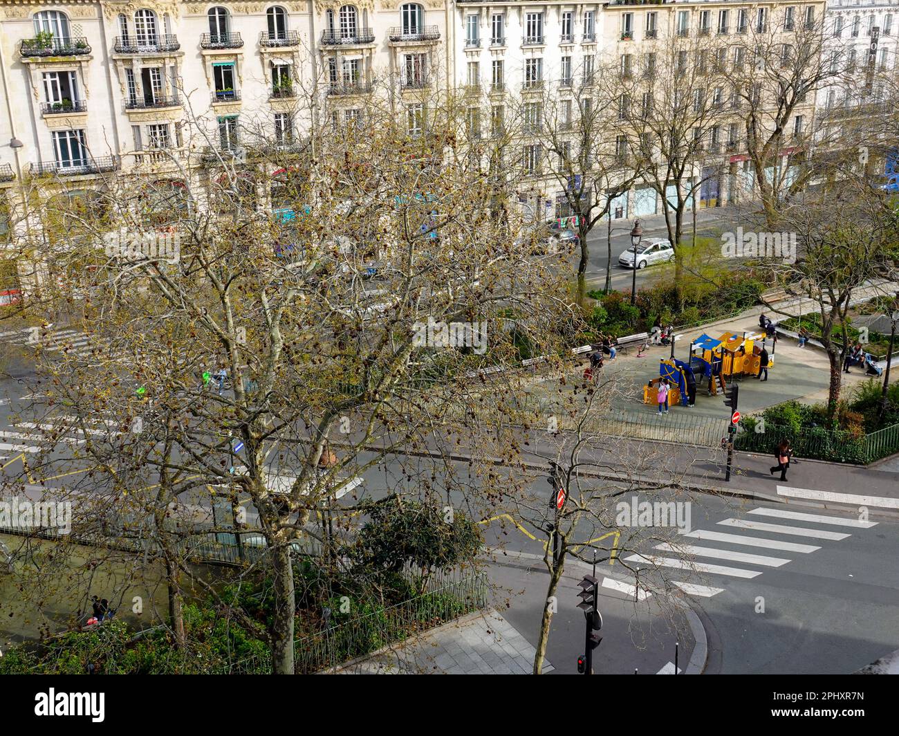 Children being watched by parents, carers, as they play on a city playground. Every day life on Bd Richard-Lenoir, Paris, France. Stock Photo
