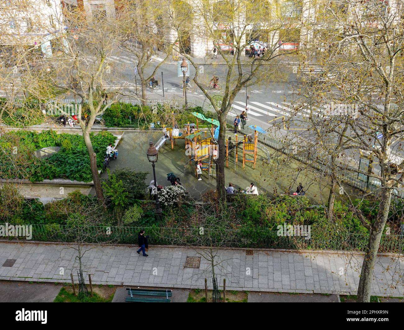Children being watched by parents, carers, as they play on a city playground. Every day life on Bd Richard-Lenoir, Paris, France. Stock Photo