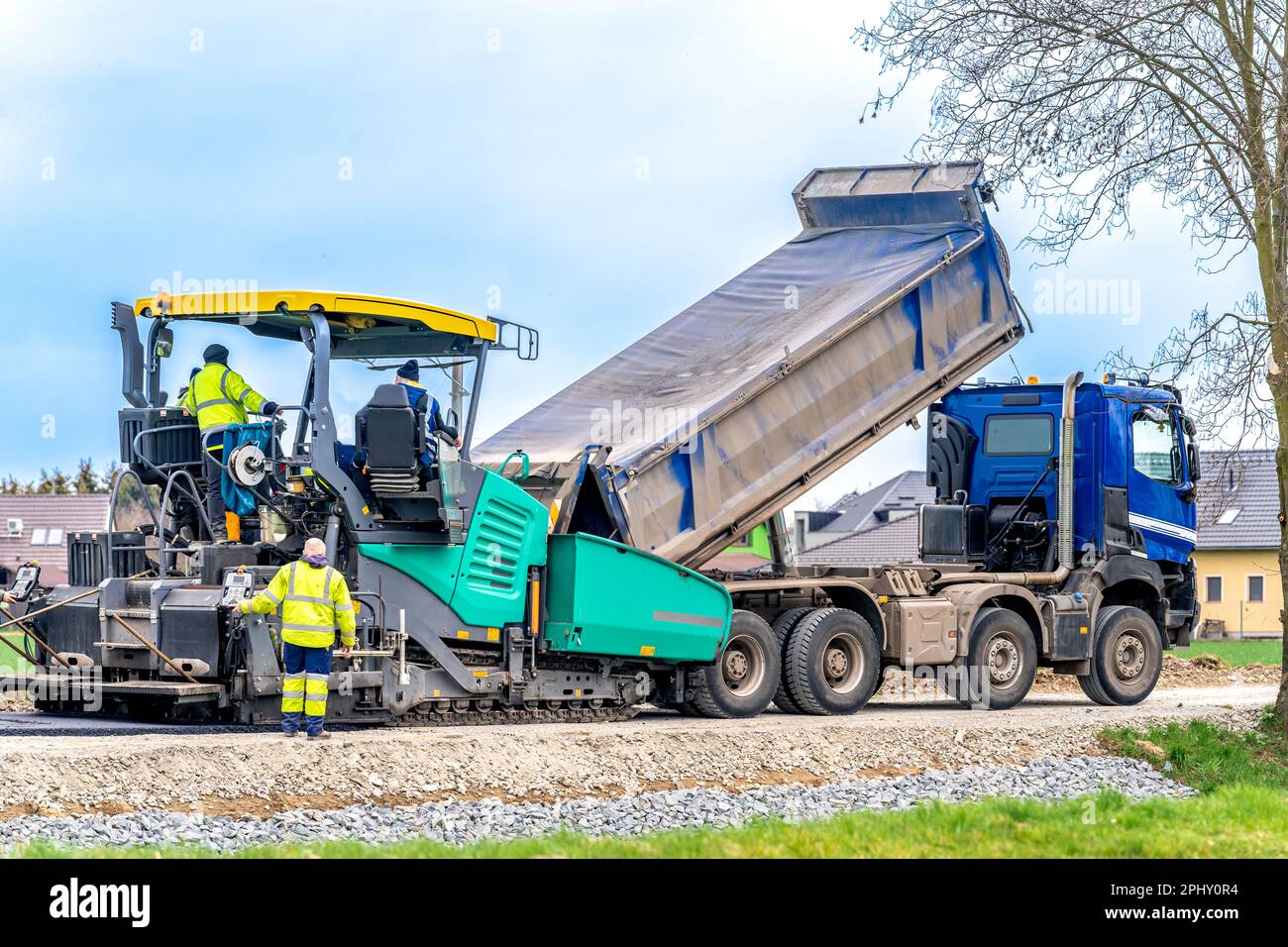 machine asphalting of roads. truck with asphalt. the creation of a new ...