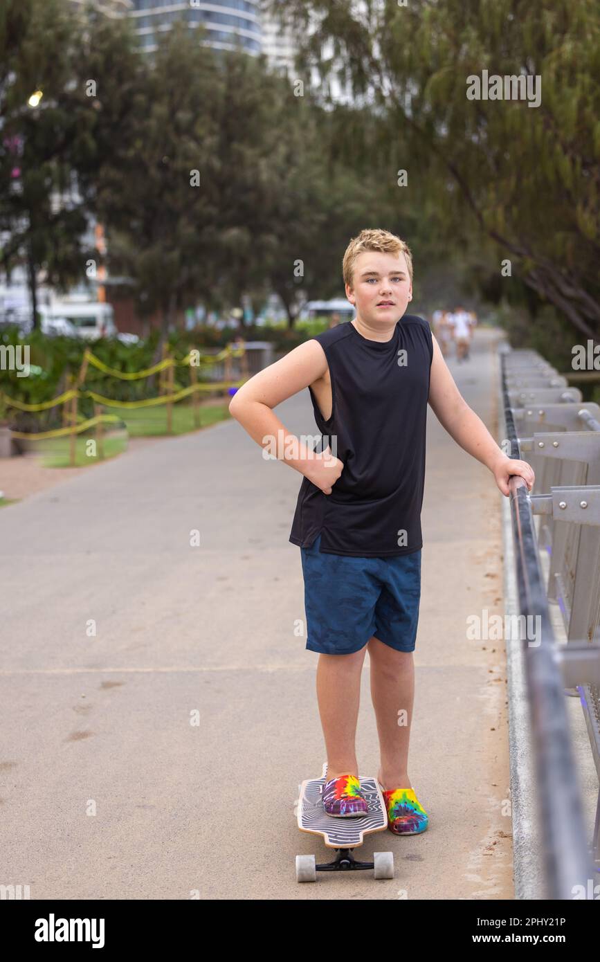 Boy skate boarding along the Main Beach esplanade at Surfers Paradise on the Gold Coast in Queensland, Australia Stock Photo