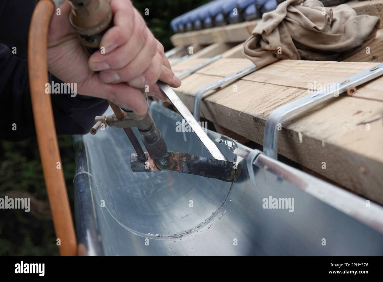 roofer soldering the seam of a gutter, Germany Stock Photo Alamy