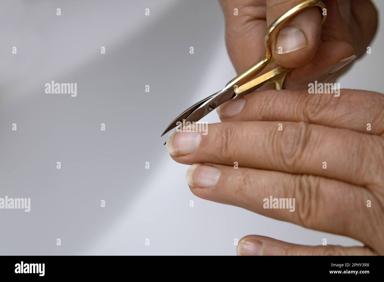 cutting fingernails with a nail scissors Stock Photo Alamy