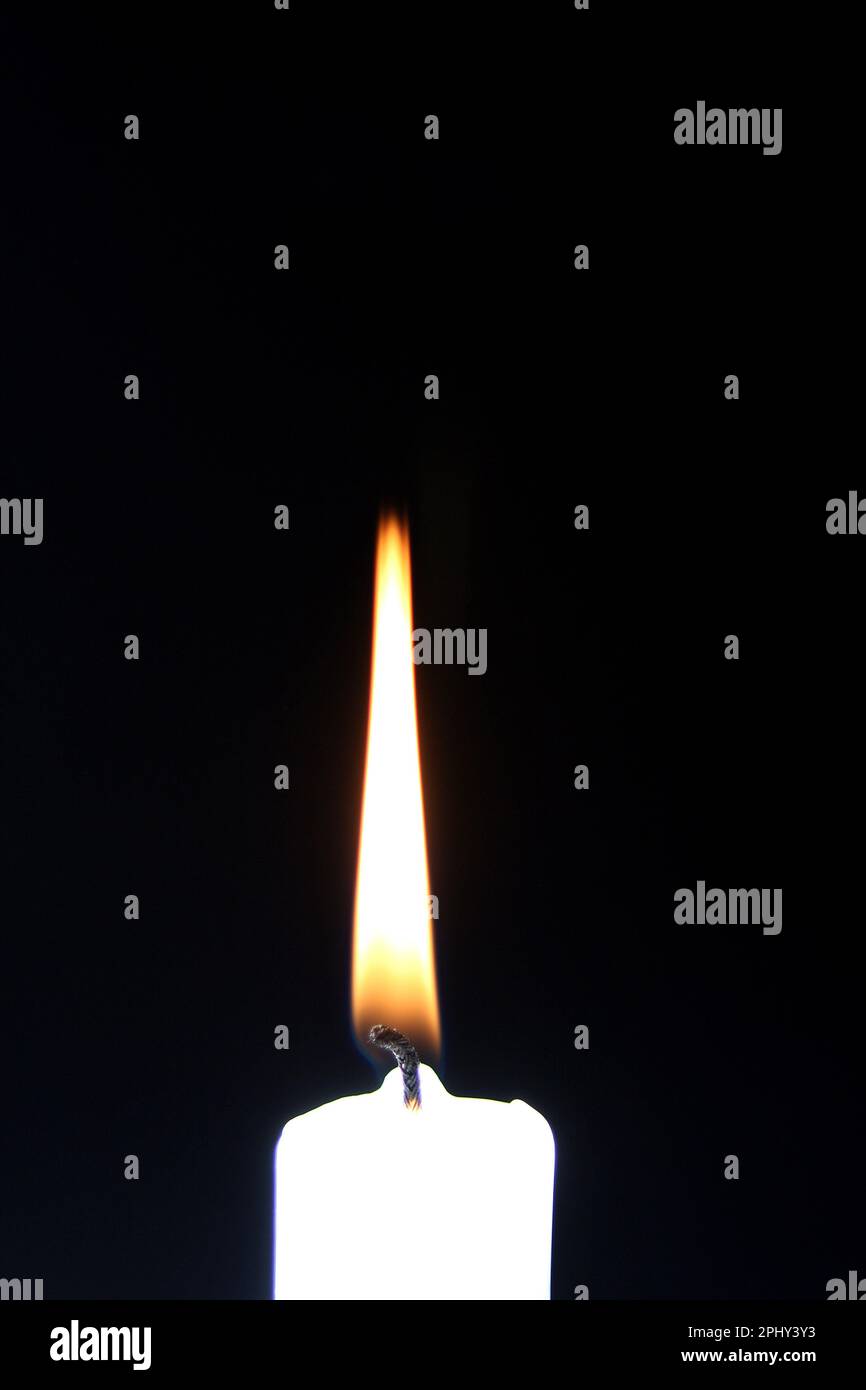 burning white candle on black background Stock Photo - Alamy