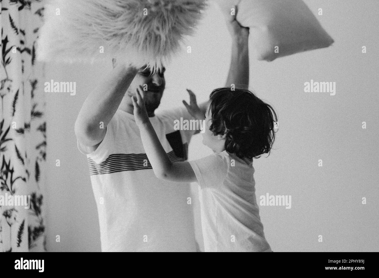 Father and his son are playing and hugging at home. Stock Photo