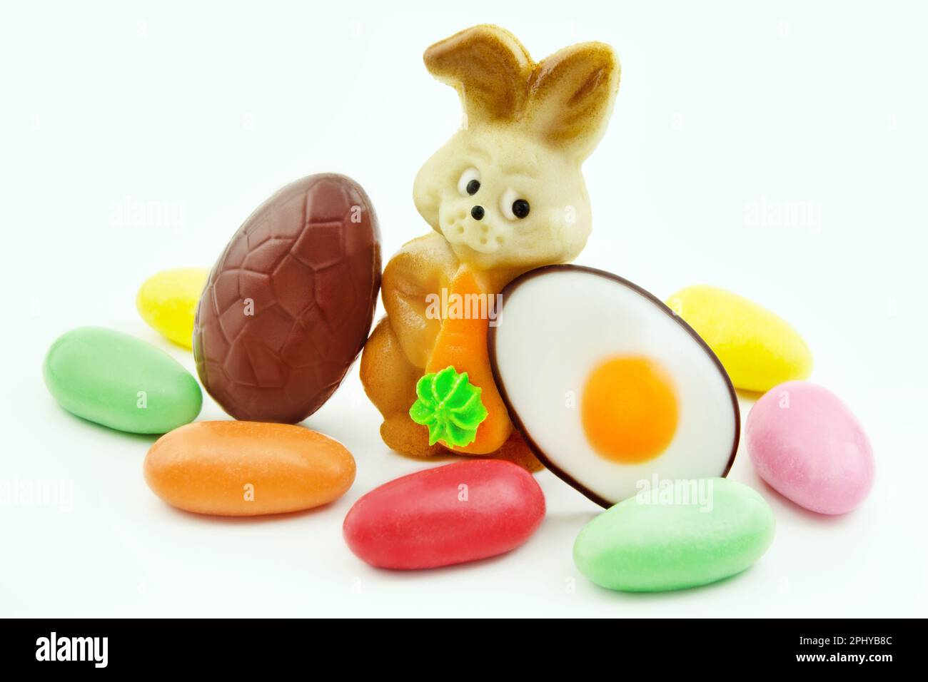 Various sweets and Easter Bunny with eggs Stock Photo