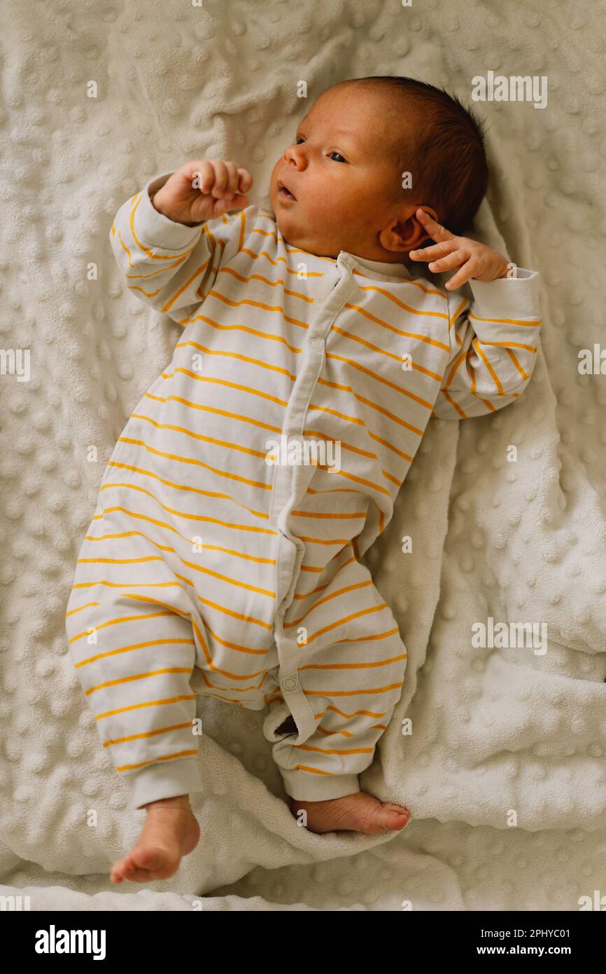 Cute emotional newborn little baby boy in crib Stock Photo - Alamy, image size:866x1390
