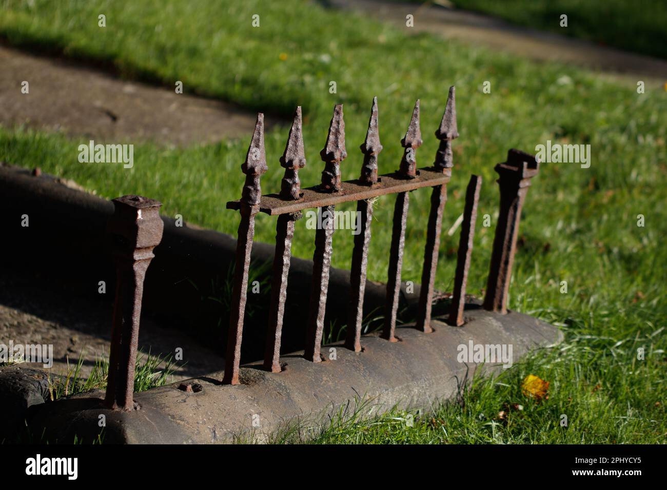 A high resolution closeup of a metal fence with multiple spiked bars