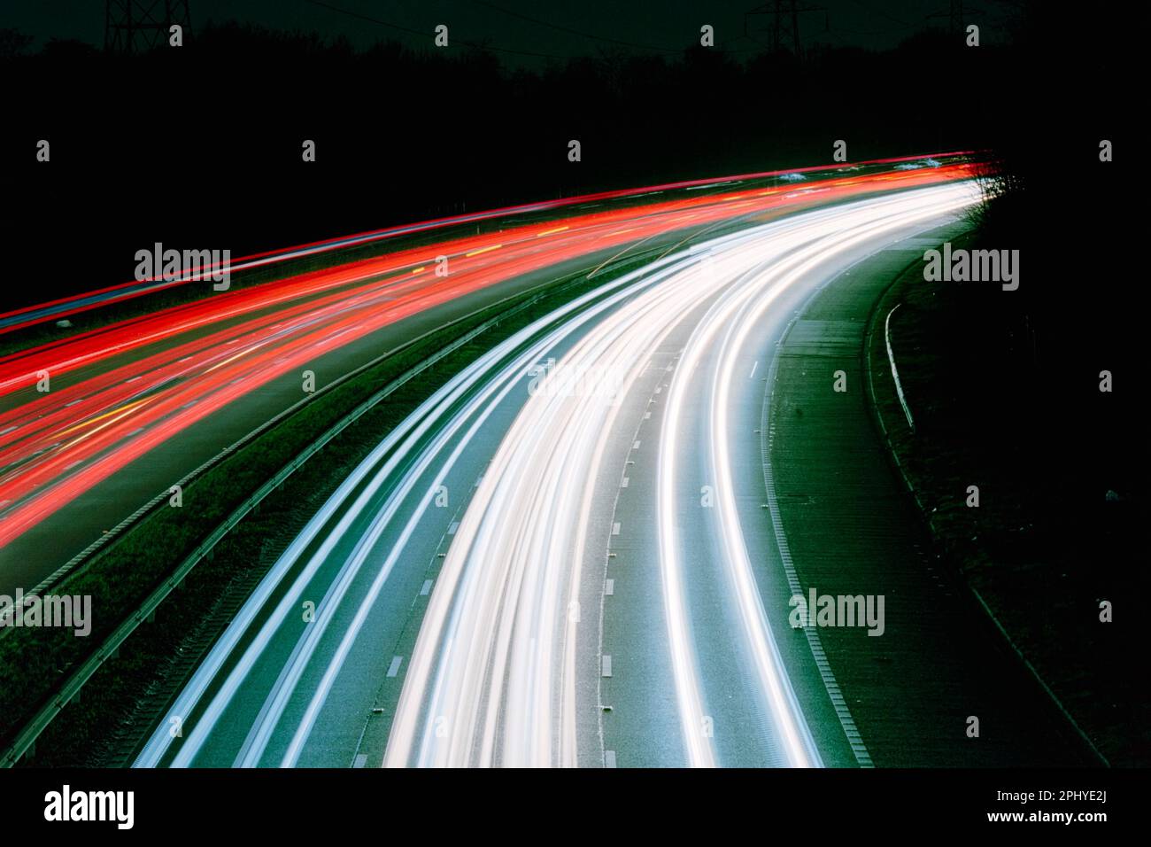 Light trails from moving traffic on the M60 motorway, Greater Manchester, England, UK. Theme or concept of travel, motion, speed, urban, commuting Stock Photo