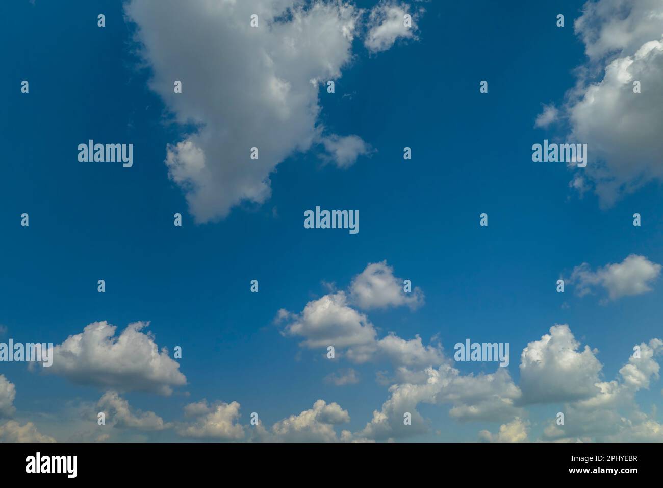 White puffy cumulus clouds on summer blue sky Stock Photo - Alamy