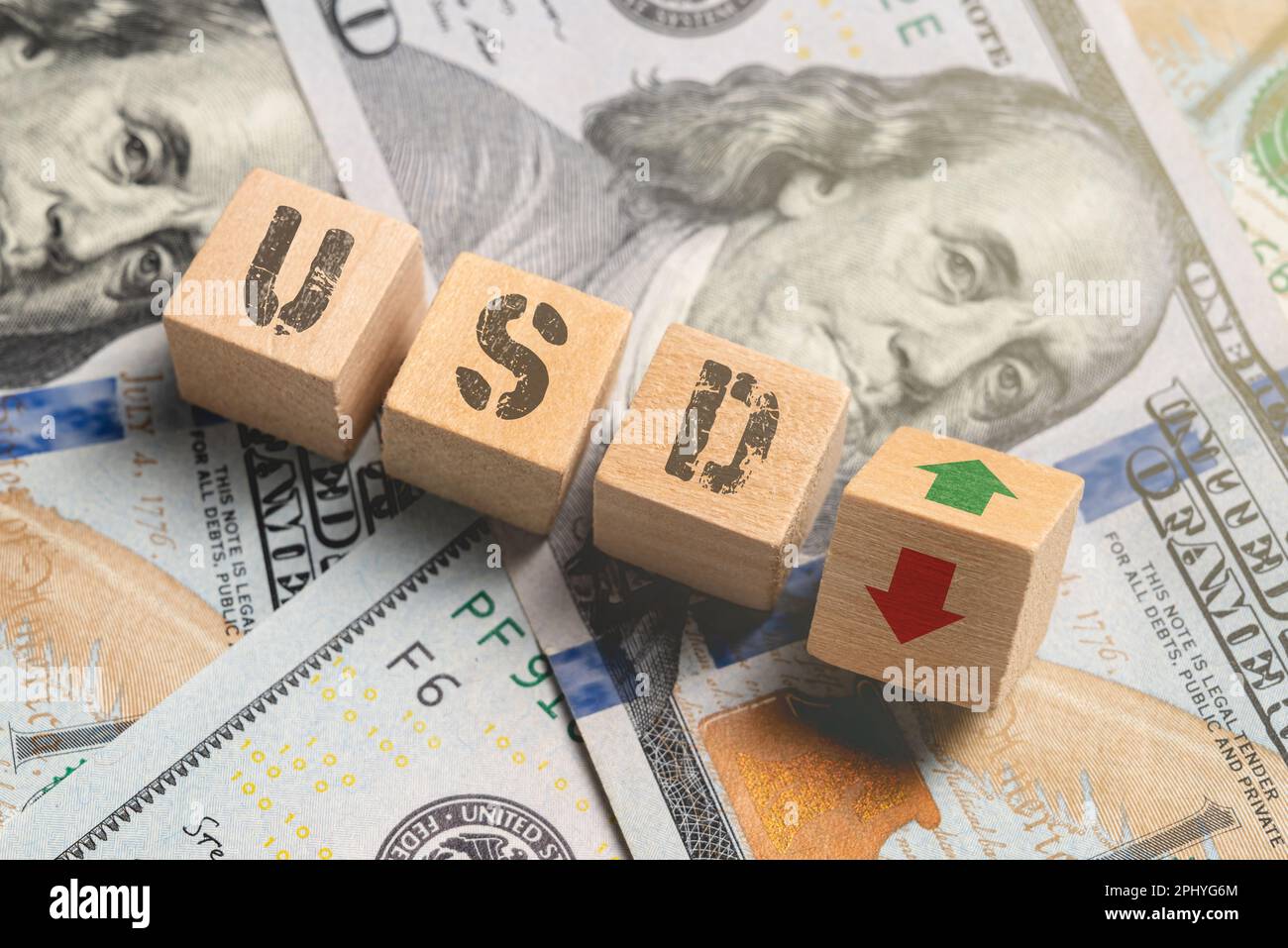 Wooden cubes with USD and up-down arrows over 100 usd. Stock Photo
