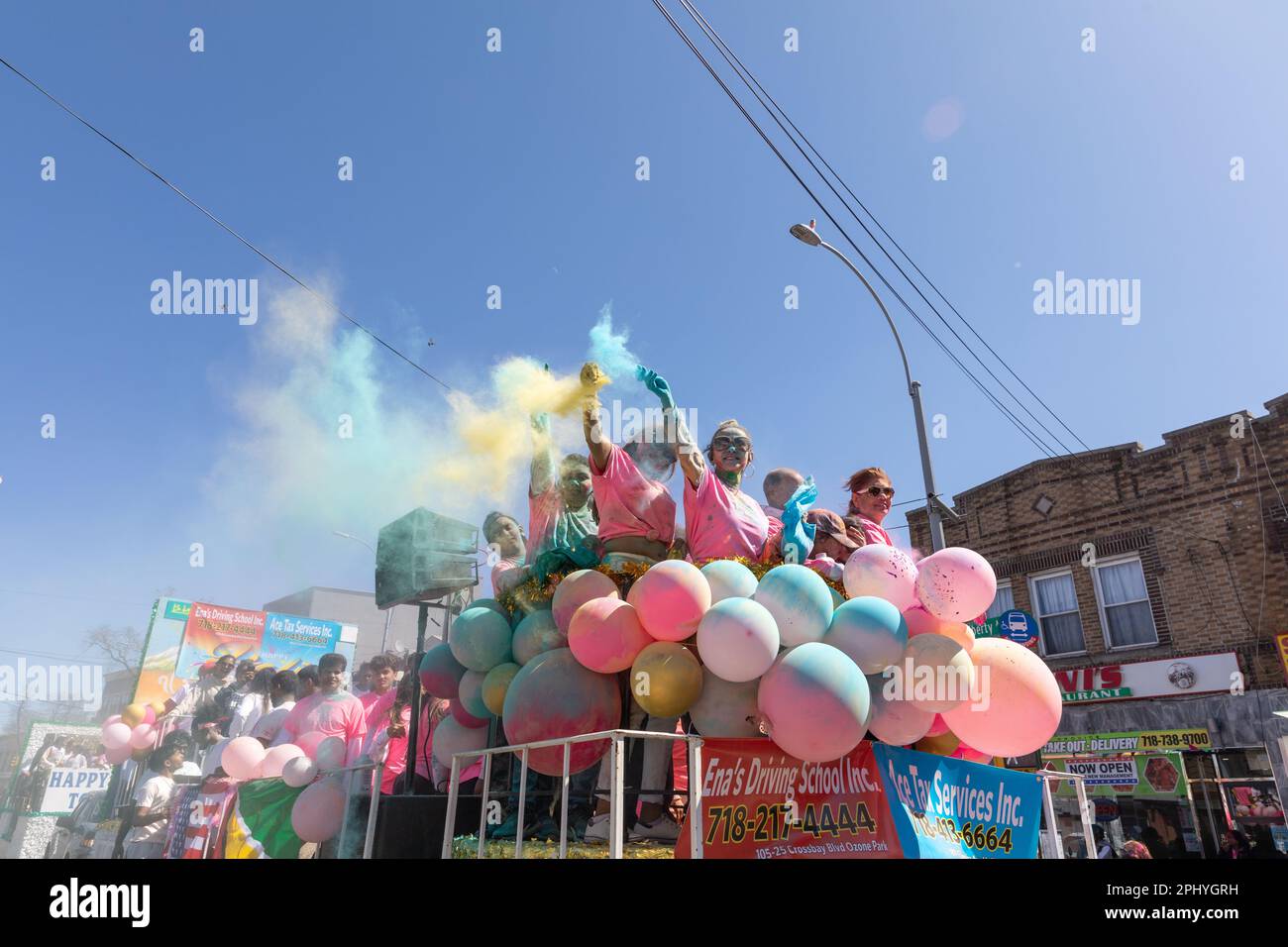 A group of diverse people spreading color powder on each other at the