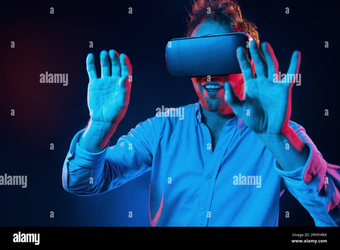 Virtual glasses gaming experience. Neon lighting. Young european man is