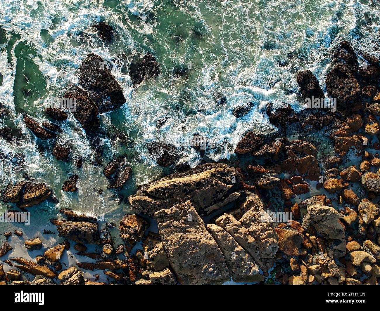 Picture of coast with rocky shoreline and ocean waves crashing against ...