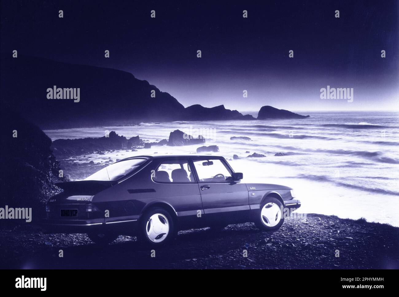 Scanned image of a Classic Saab Turbo car on a deserted beach in Devon, UK shot on film circa 1994 Stock Photo