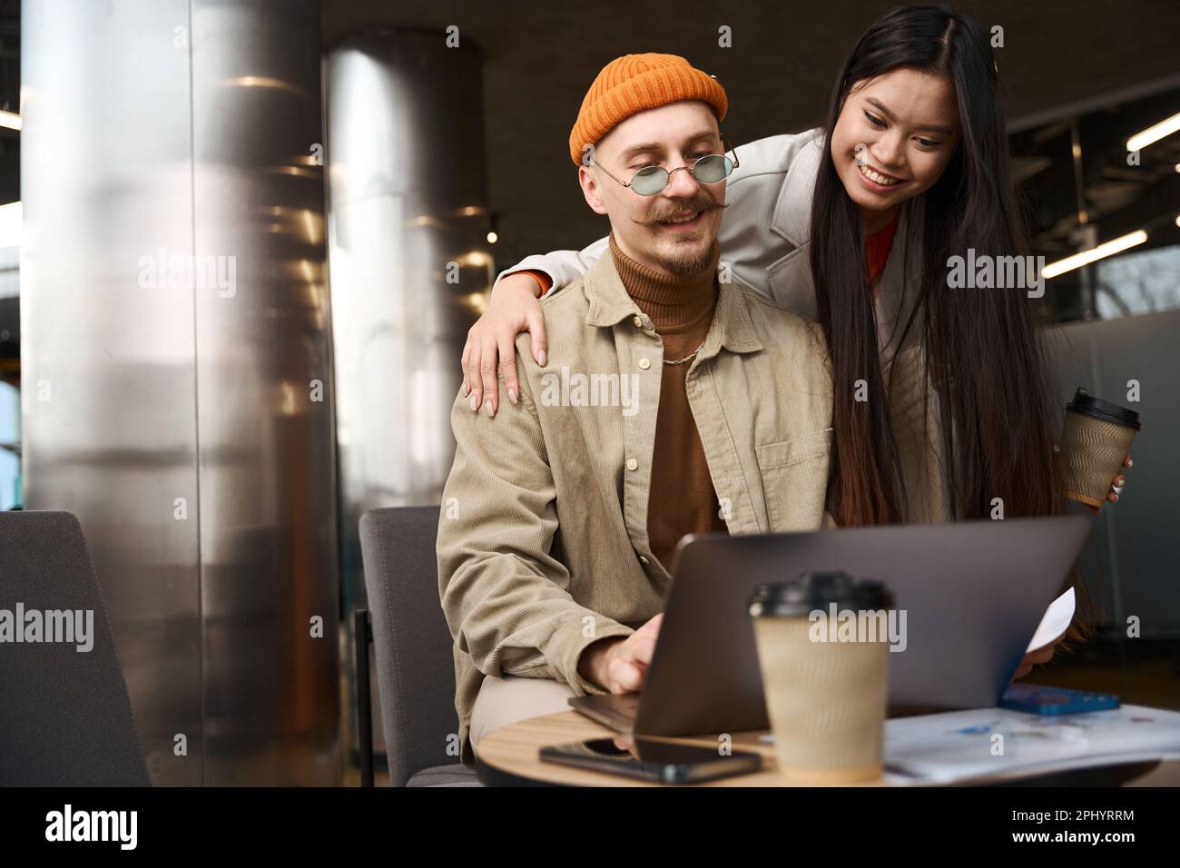 Cheerful young corporate workers involved in work Stock Photo