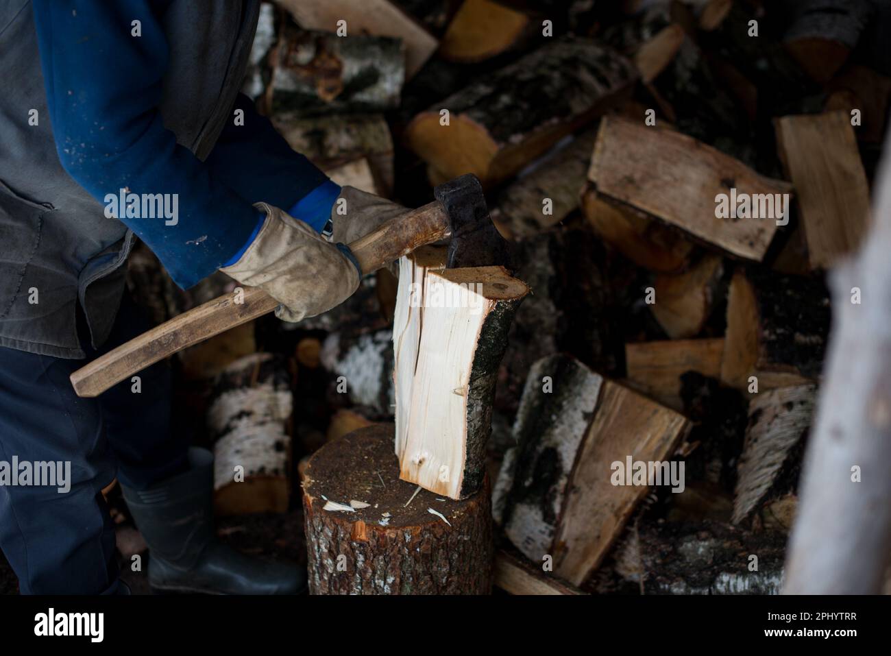 Grandfather chopping firewood Stock Photo