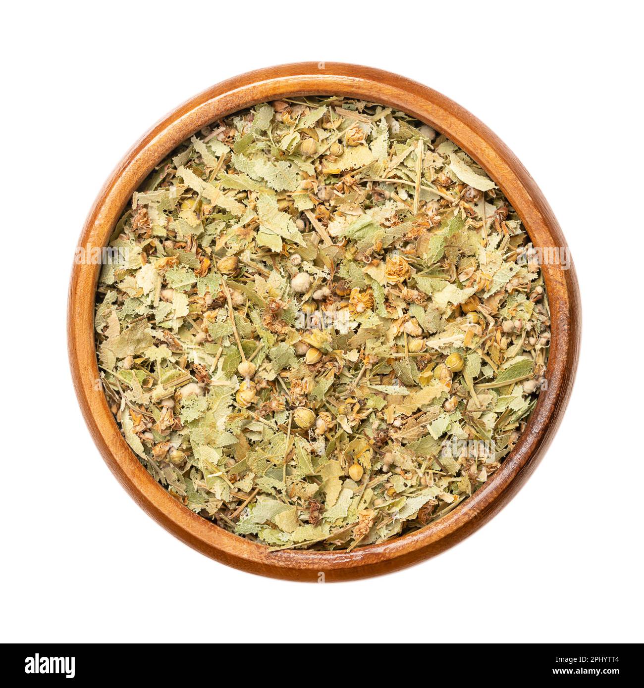 Dried linden flowers, in a wooden bowl. Flowers, fruits and bract leaves of the large-leaved linden or lime tree, Tilia platyphyllos. Herbal tea. Stock Photo