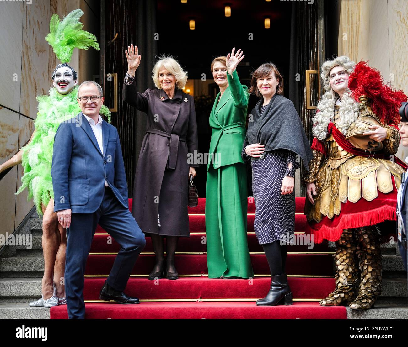 Berlin, Germany. 30th Mar, 2023. Royal wife Camilla (3rd from left) and Elke Büdenbender (3rd from right), wife of the German president, stand together with the artistic director duo Susanne Moser (2nd from right) and Philip Bröking and ensemble members in front of the Komische Oper at the beginning of the visit. Credit: Kay Nietfeld/dpa/Alamy Live News Stock Photo