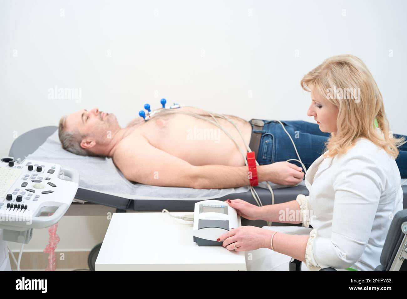 Patient getting heart rate monitored with electrocardiogram equipment ...