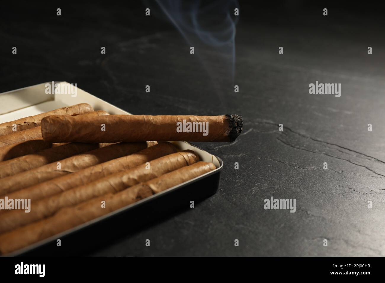 Many cigars in box on black table, closeup Stock Photo Alamy