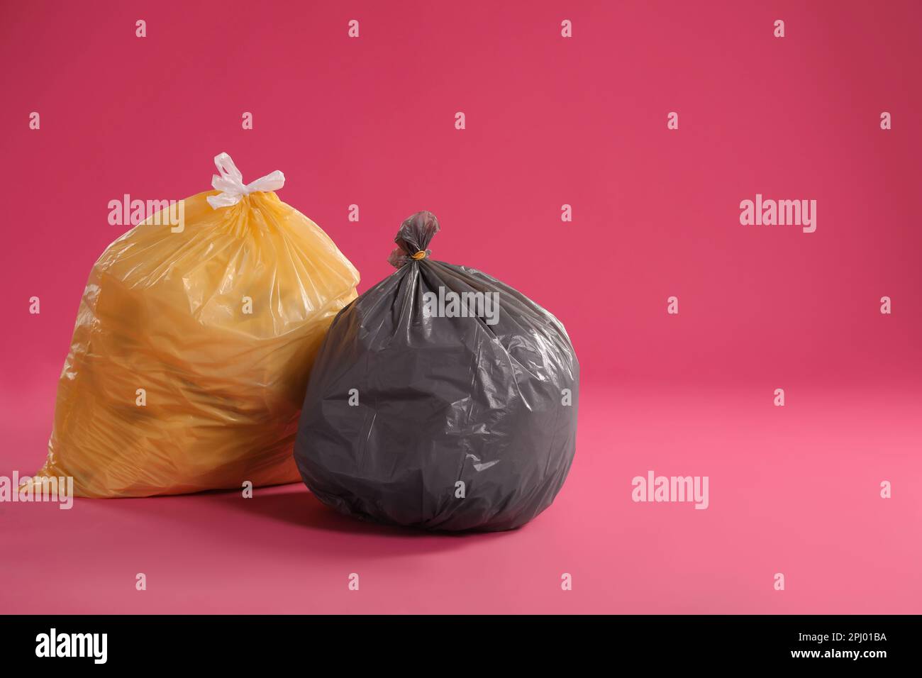 https://c8.alamy.com/comp/2PJ01BA/trash-bags-full-of-garbage-on-pink-background-space-for-text-2PJ01BA.jpg