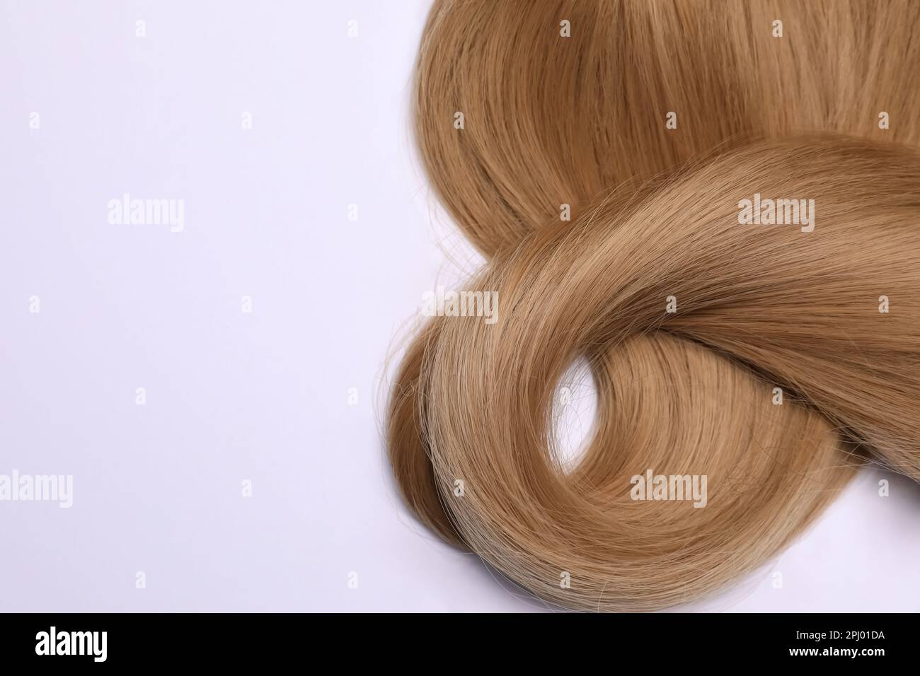Beautiful dark blonde straight hair on white background, top view Stock Photo