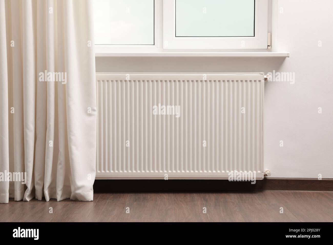 Modern radiator at home. Central heating system Stock Photo - Alamy