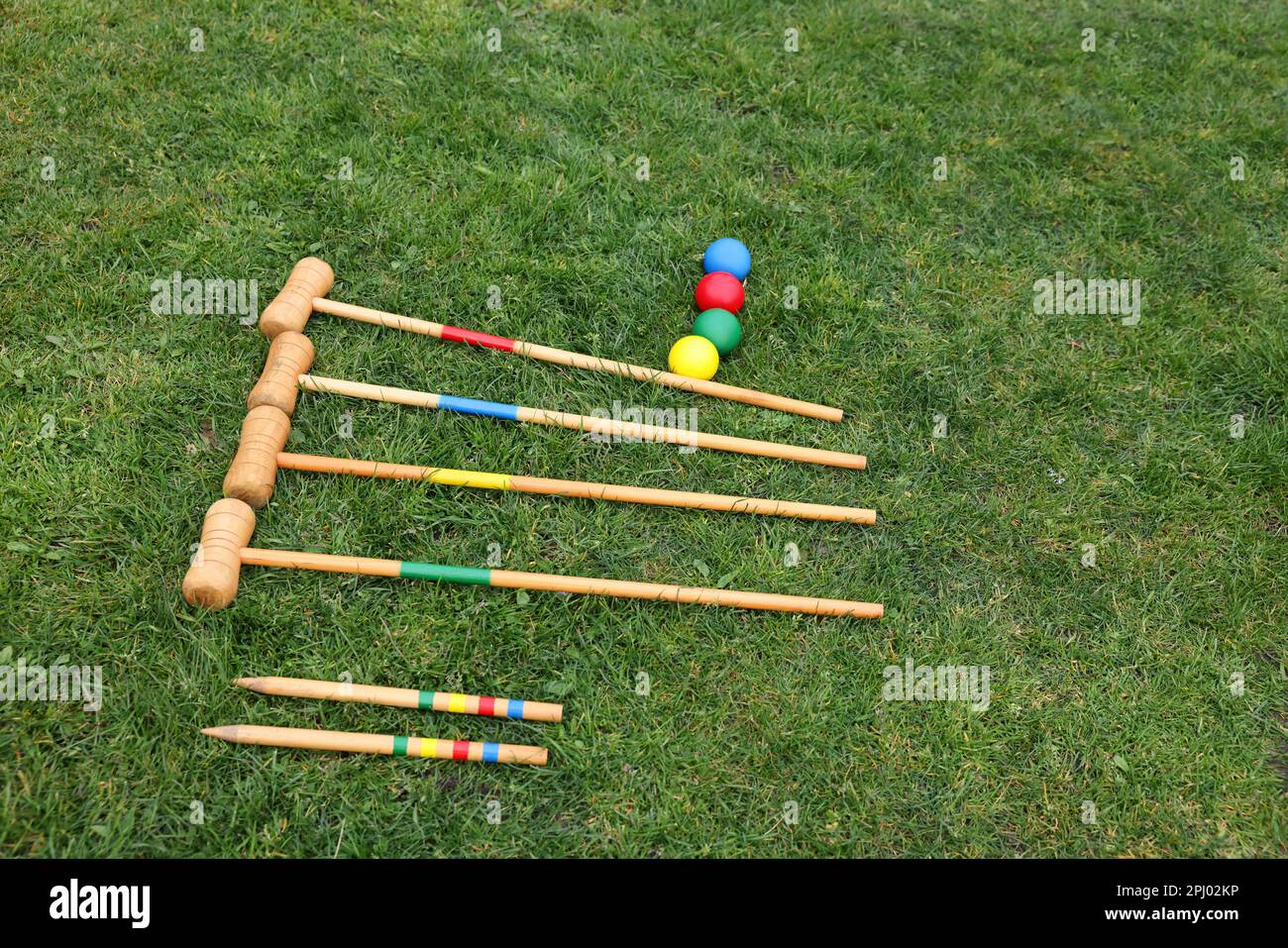 Set of croquet equipment on green grass Stock Photo Alamy