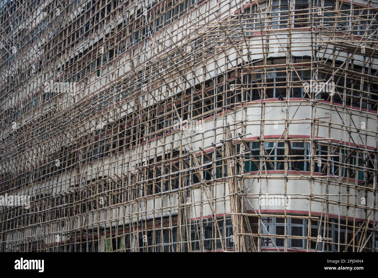 Bamboo scaffolding around an apartment block, Hong Kong, China Stock Photo