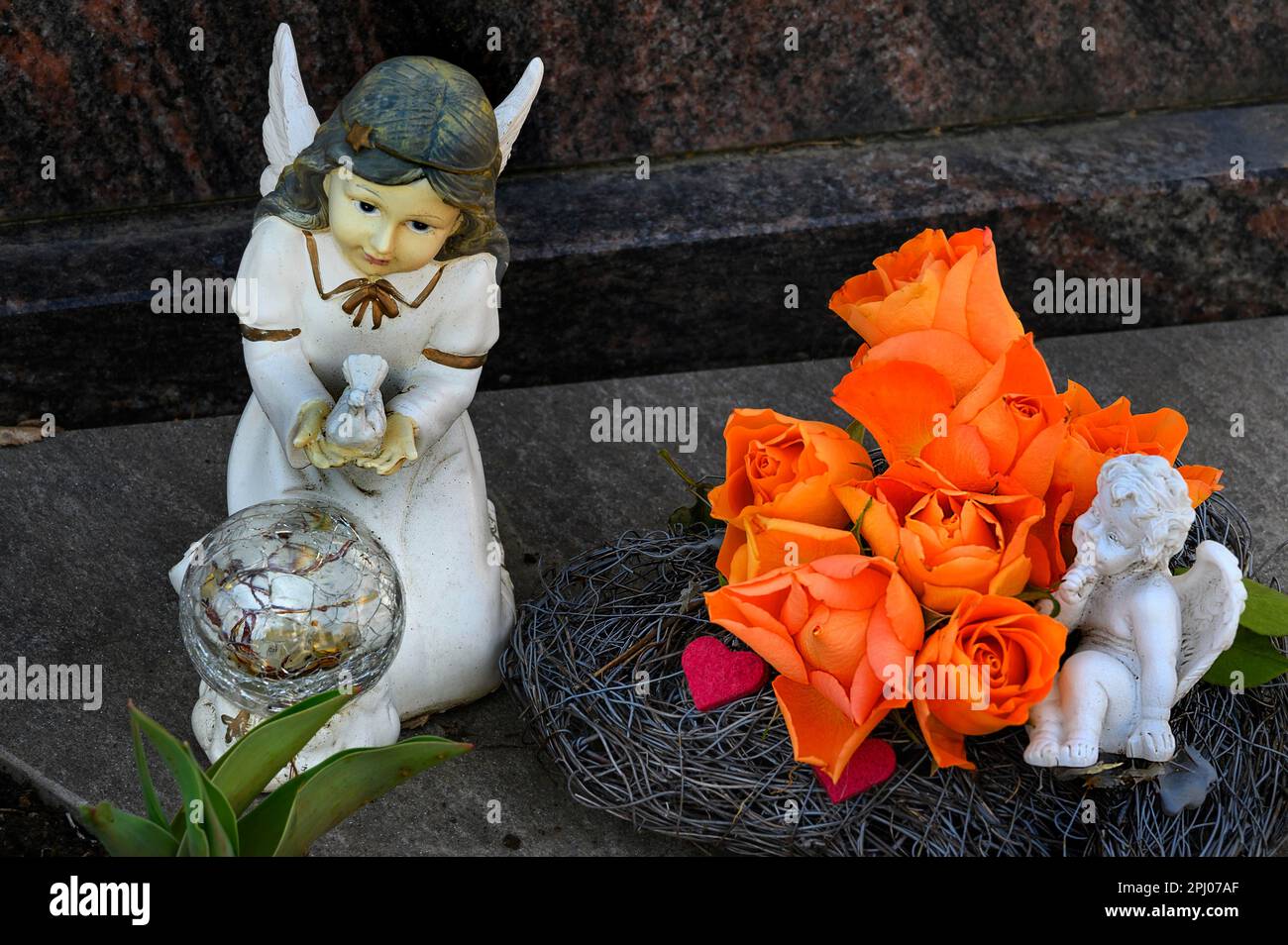Grave decoration with artificial roses, angel and putto, Allgaeu, Bavaria, Germany Stock Photo