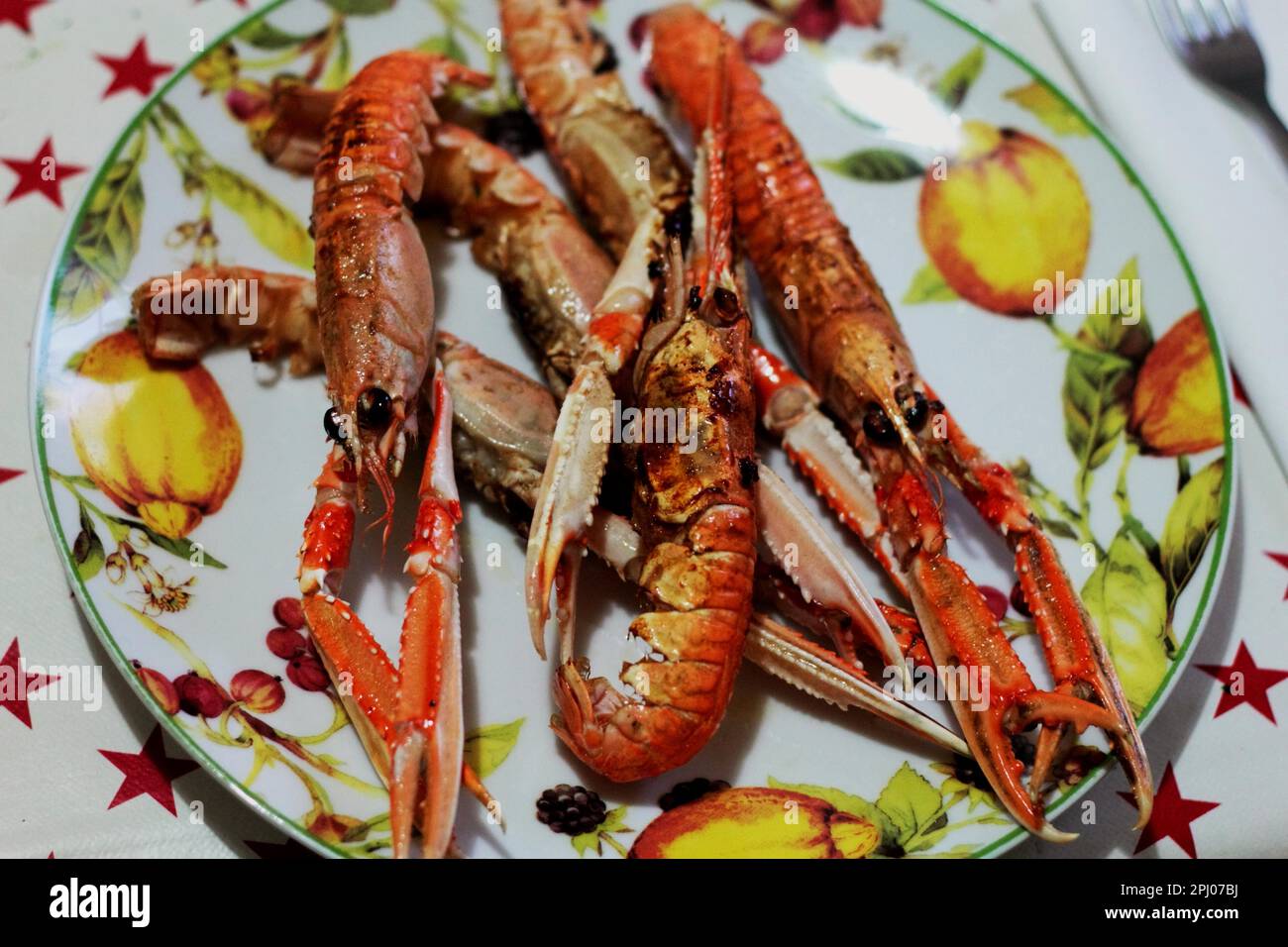Scampi (Nephrops norvegicus) cooked in a cast iron pan. Fresh shellfish Stock Photo