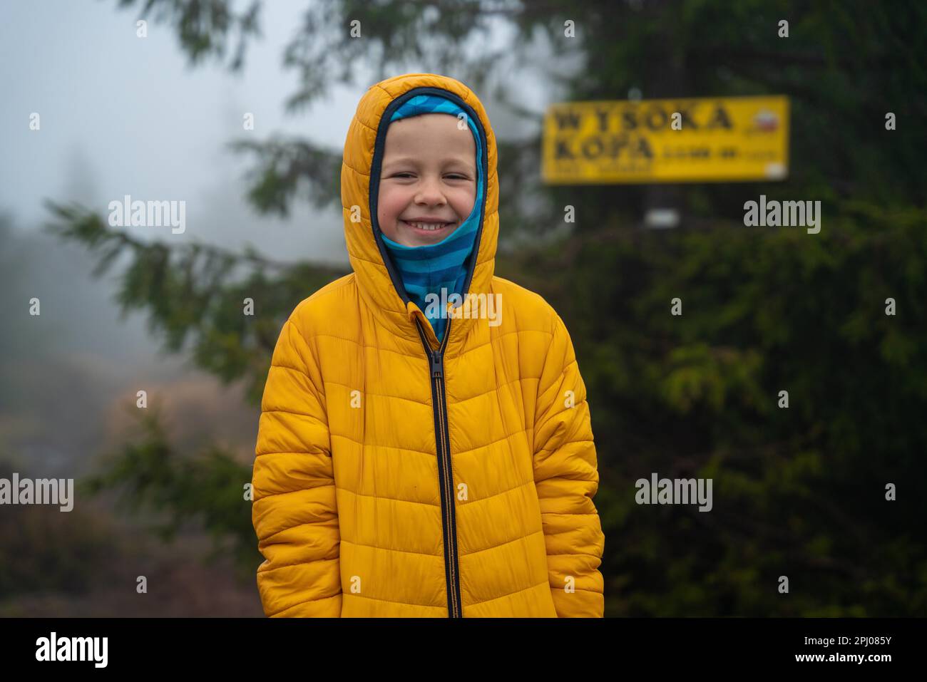 Happy and smiling child after reaching a small mountain peak. Polish mountains Stock Photo