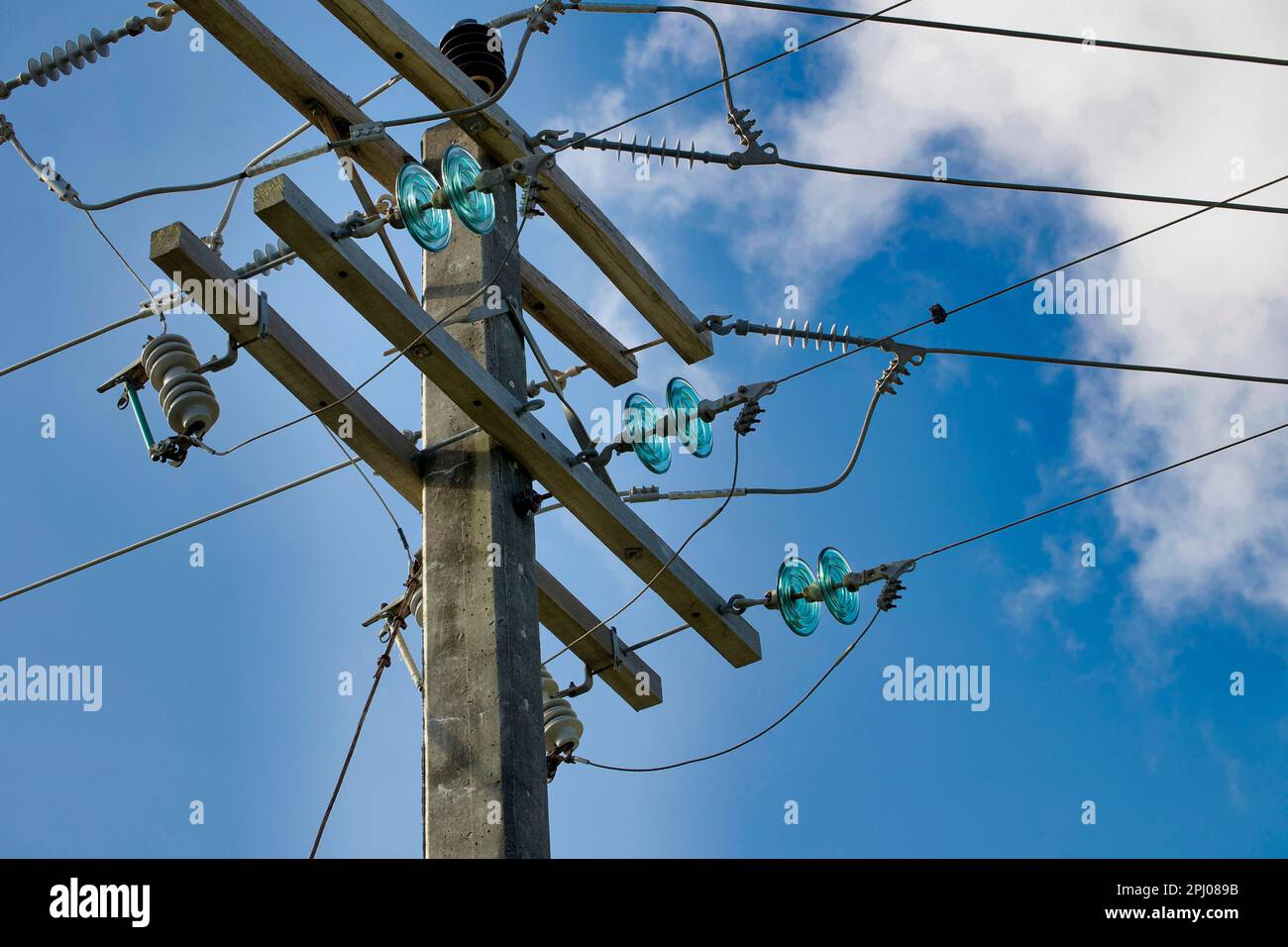 Concrete electricity poles with porcelain and glass insulators