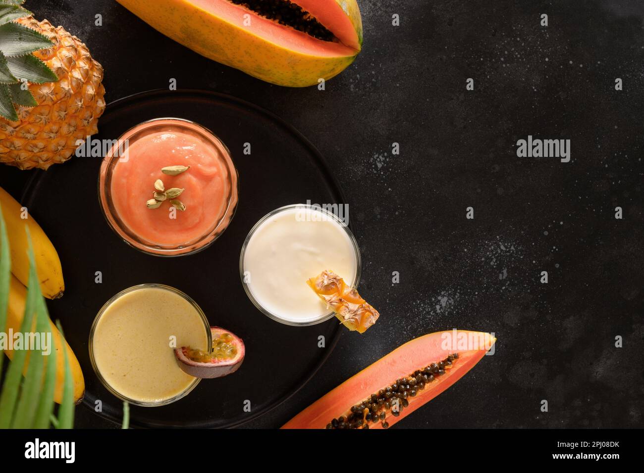 Asian traditional pineapple, papaya, passion fruit lassi or smoothie in