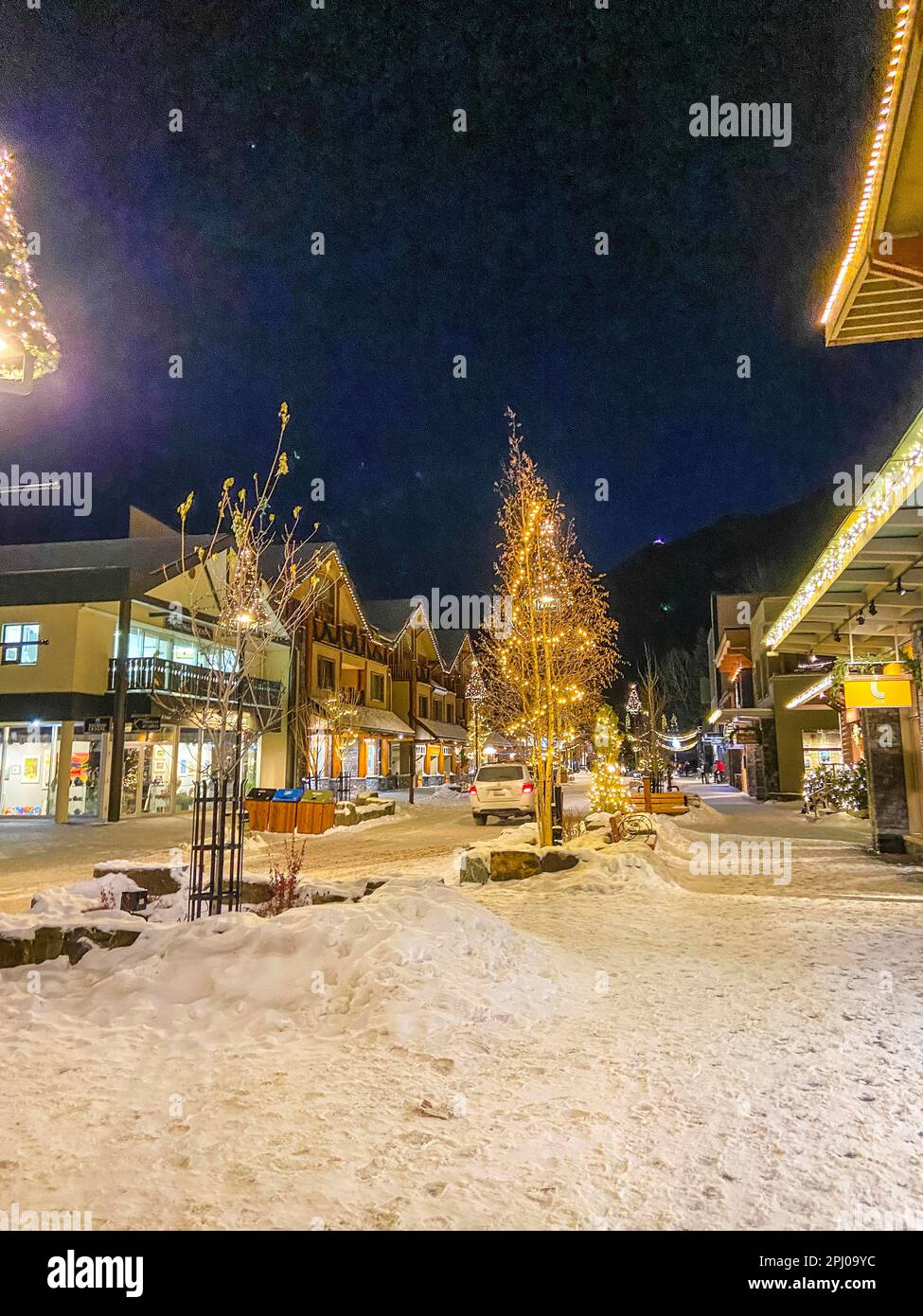 Winter street with Christmas decorations in Banff, Alberta, Canada ...