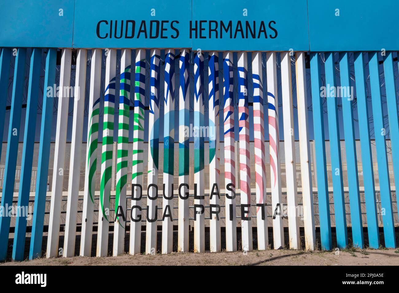 Agua Prieta, Mexico, Artwork proclaims Agua Prieta and Douglas, Arizona sister cities. The art is painted on the U.S.-Mexico border fence that Stock Photo