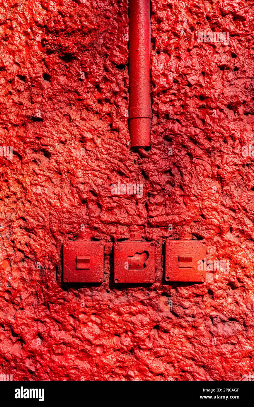 Red wall with old light switches, RAW site, former Reichsbahn repair works, Friedrichshain, Berlin, Germany Stock Photo