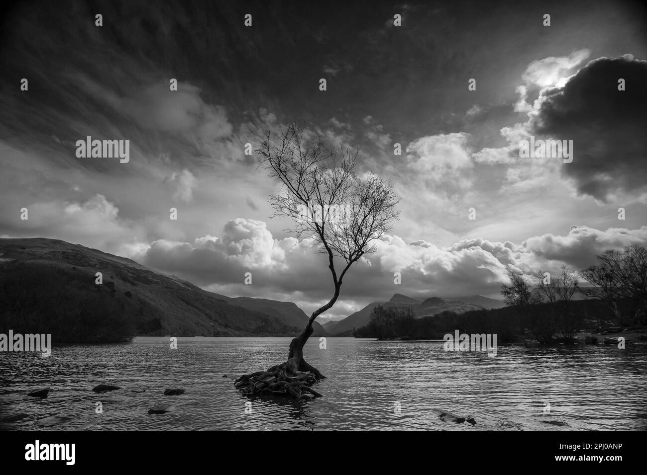 Moody landscape view across the water of Llyn Padarn, in North Wales, UK. Stock Photo